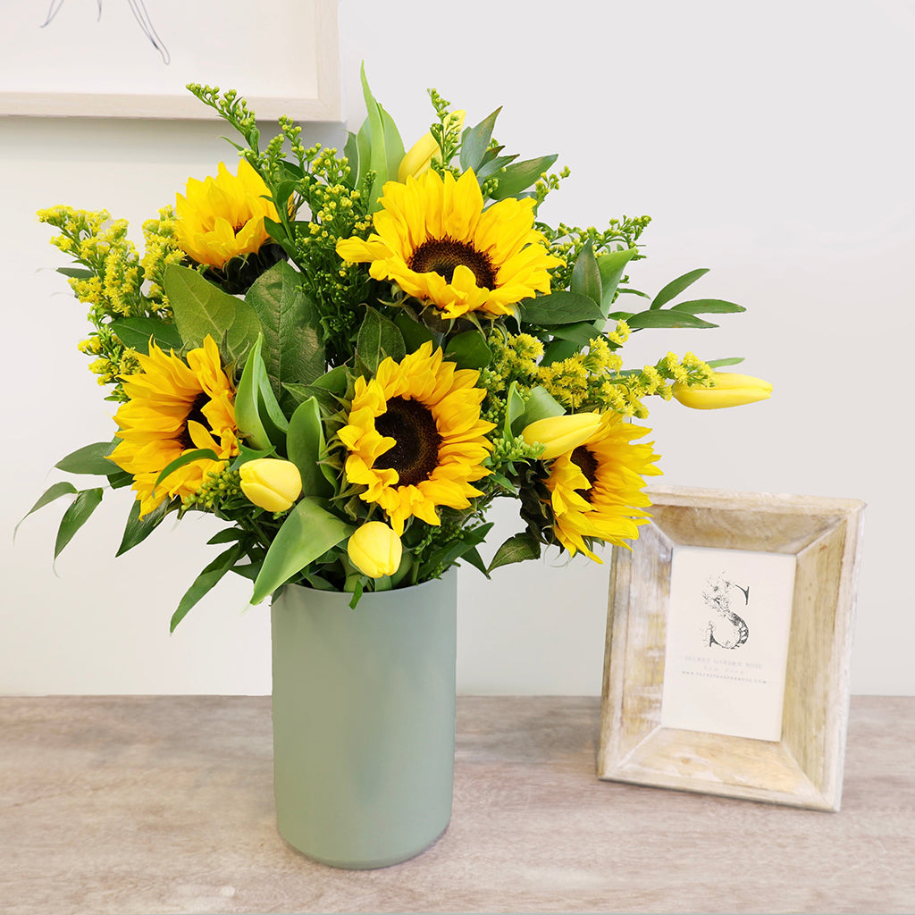 Bouquet of Sunflowers, Tulips, and Solidagos with Lemon Leaves and Ruscus greeneries.