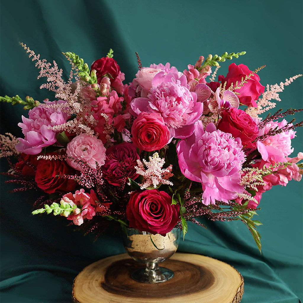 Bouquet of Hot Spot Roses, Pink Ranunculus, Darcey Garden Roses, Pink Peonies, Orchids, Snapdragons, Calycina, and Astilbes.
