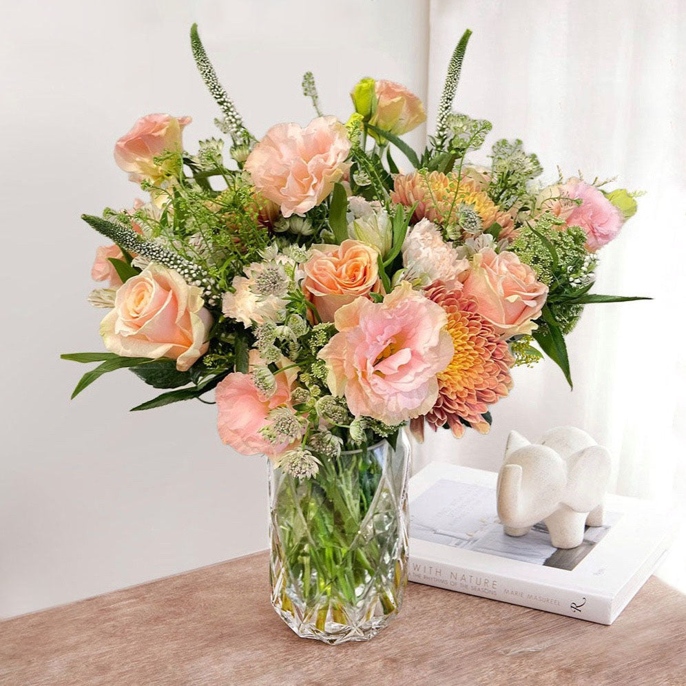 A bouquet of lisianthus, phoenix roses, chrysanthemum, alstromeria, astrantias and thlaspi.