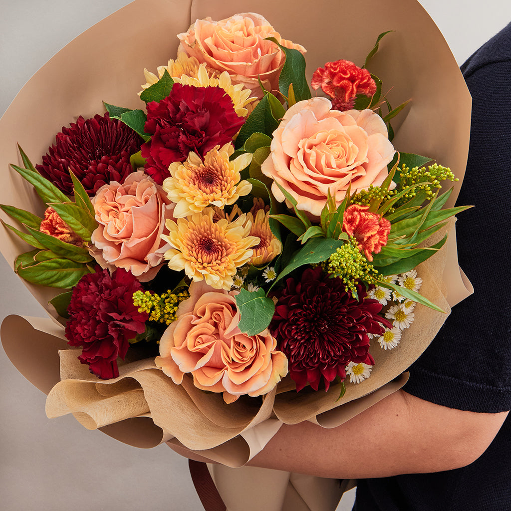 Bouquet of Green Hydrangeas, Phoenix Roses, Cymbidiums, Celosia, Burgundy Mums, Pompoms, Solidago, and Red Carnations with Lemon Leave greeneries.