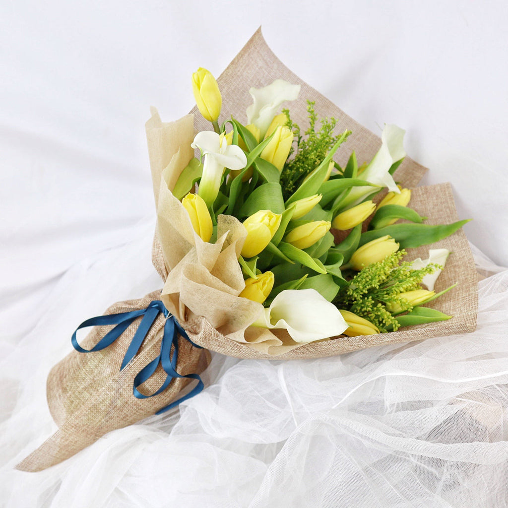 Bundle of Yellow Tulips, Calla Lilies, and Solidagos with Decorative Greens greeneries.